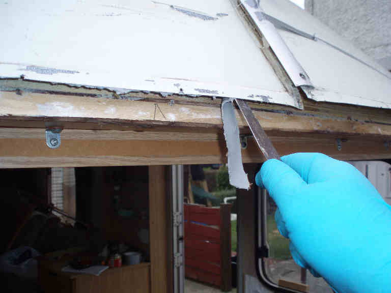 Removing the old mastic with a knife